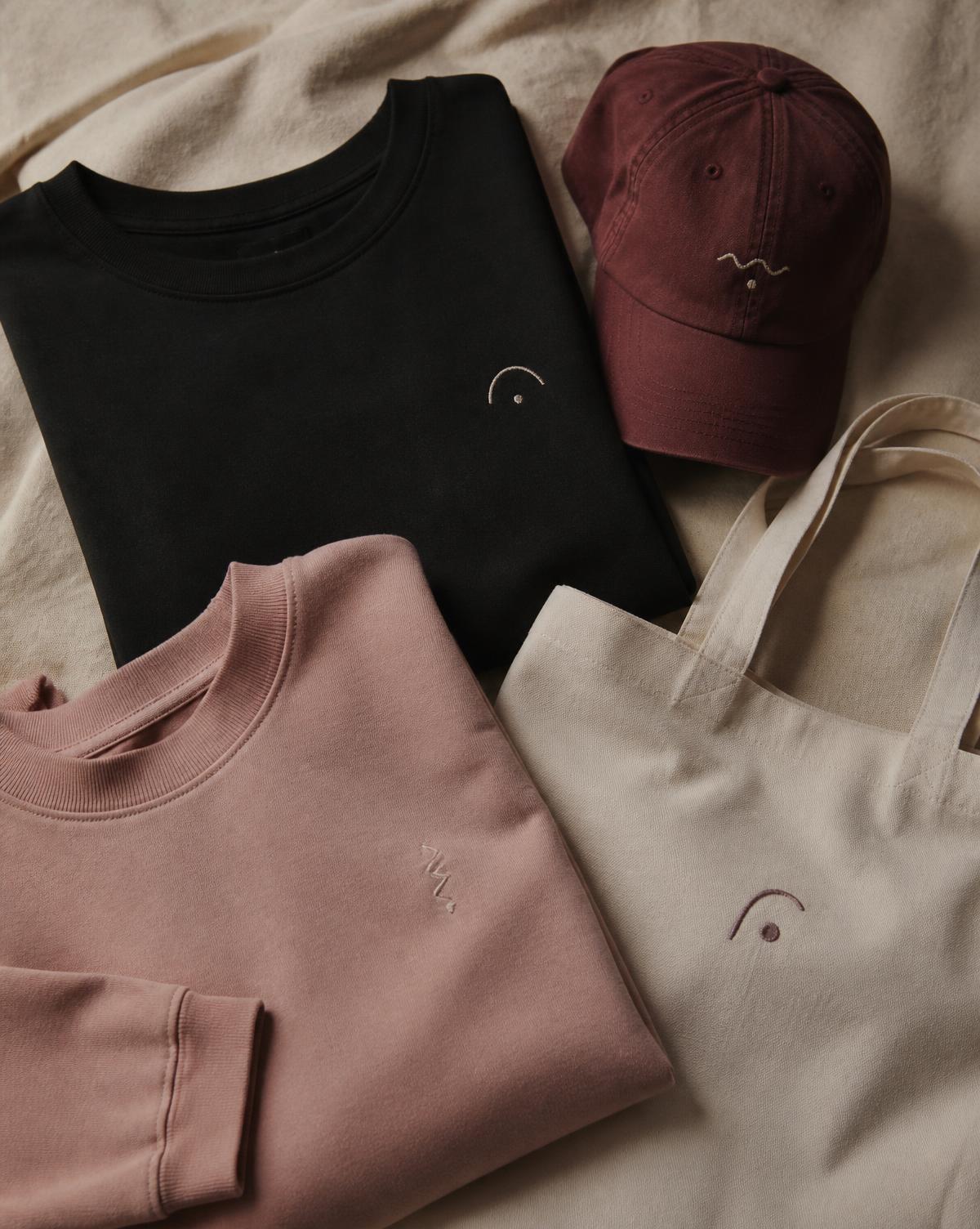 Folded Baby Mama Society streetwear collection in black, blush, burgundy and bone